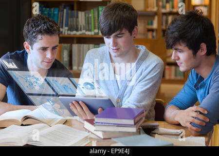 Serious students working on their digital tablet Stock Photo