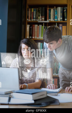 Serious students analysing graphs on their digital interface Stock Photo