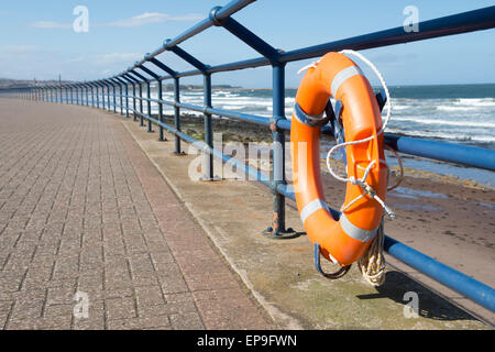 Lifebelt on the promenade railing at Spittal Beach, Berwick upon Tweed, Northumberland, England Stock Photo