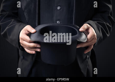 closeup of top hat in magician hands isolated Stock Photo