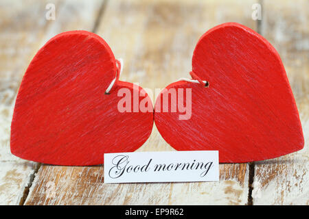 Good morning card with two red wooden hearts Stock Photo