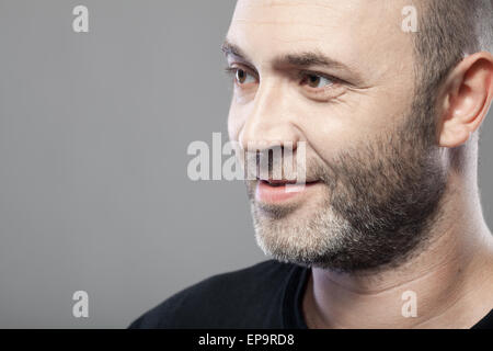 man looking to the left isolated on gray Stock Photo