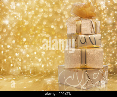 Beautiful gift boxes in gold paper with a silk rose on abstract Stock Photo