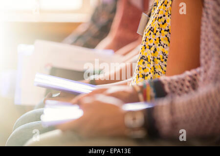 audience sitting in a row paperwork Stock Photo