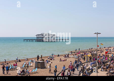 People enjoying the sunshine on a sunny day at Brighton beach in East Sussex, England Stock Photo