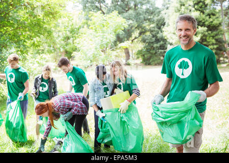 environmentalist volunteer picking up trash Stock Photo