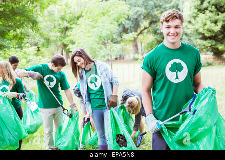 environmentalist volunteer picking up trash Stock Photo