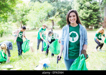 environmentalist volunteer picking up trash Stock Photo