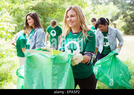 environmentalist volunteer picking up trash Stock Photo