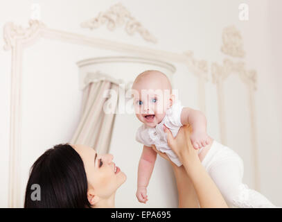 Happy smiling mother with six month old baby girl Stock Photo