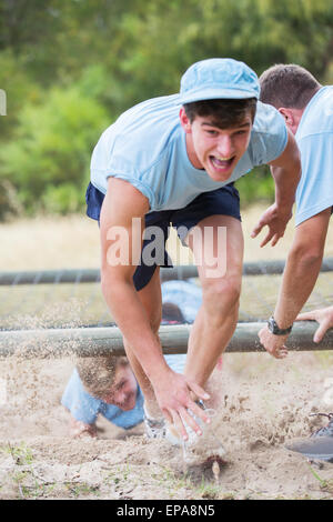 man running boot camp obstacle course Stock Photo