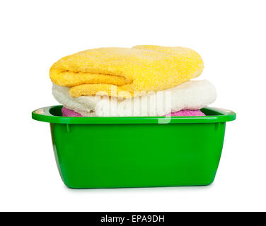 Stack of clean fresh towels in the green basin isolated on white background Stock Photo