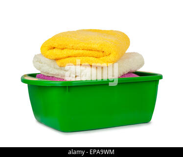 Stack of clean fresh towels in the green basin isolated on white background Stock Photo