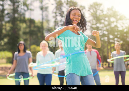 enthusiasm woman spinning plastic hoop Stock Photo