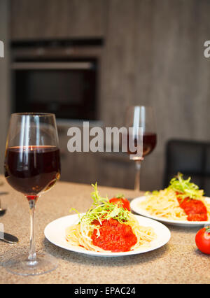 Spaghetti with tomato sauce and red wine in a kitchen Stock Photo