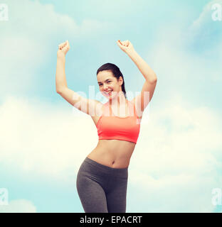 smiling teenage girl in sportswear dancing Stock Photo