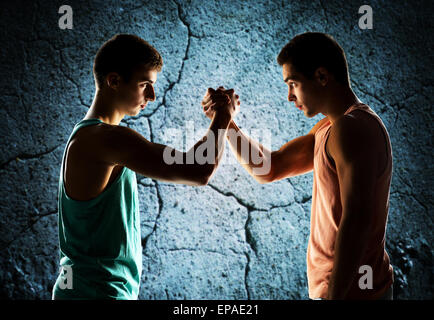 two young men arm wrestling Stock Photo