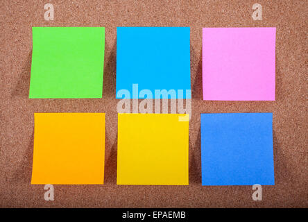 Six blank sticky notes on a noticeboard. Stock Photo