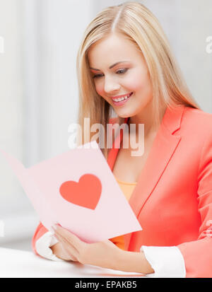 woman holding postcard with heart shape Stock Photo