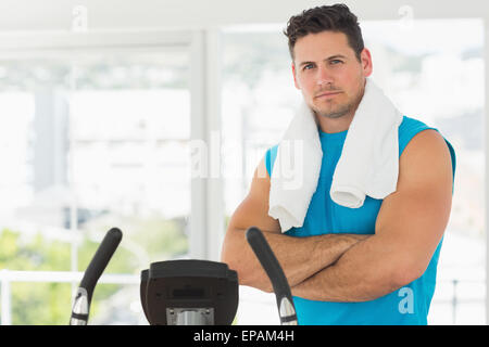 Serious young man working out at spinning class Stock Photo