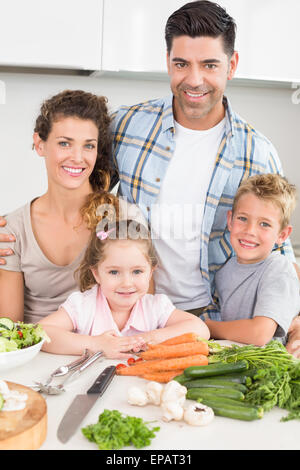 Smiling family preparing vegetables together Stock Photo