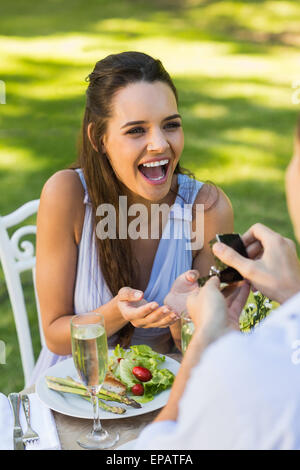 https://l450v.alamy.com/450v/epatfa/man-proposing-cheerful-woman-at-an-outdoor-caf-epatfa.jpg