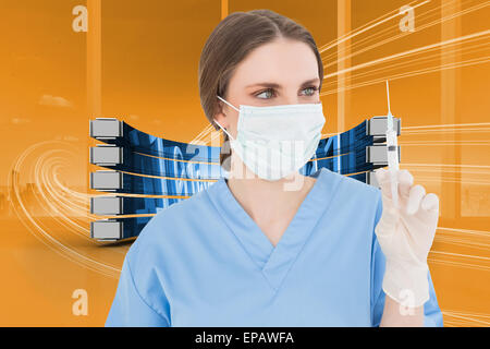 Composite image of pretty brunette female doctor holding a syringe and looking at it Stock Photo