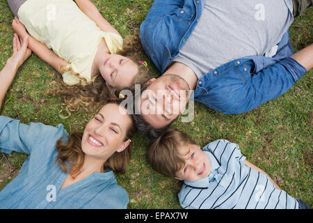 Happy parents and kids lying at park Stock Photo