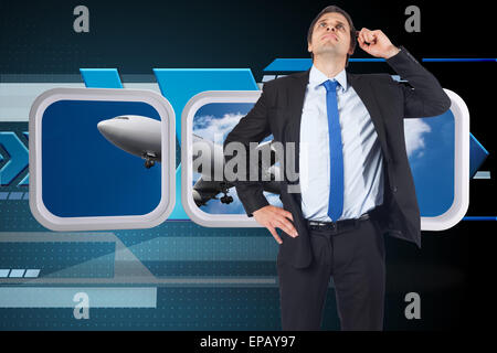Composite image of thinking businessman scratching head Stock Photo