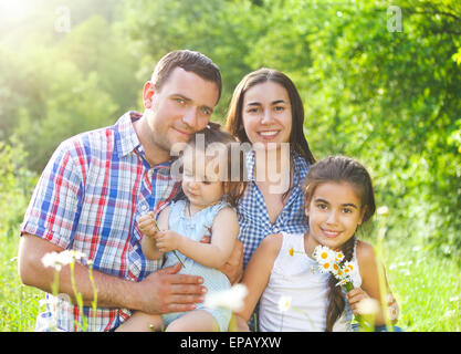 Happy young family with children in the spring forest Stock Photo