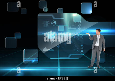 Composite image of businessman looking at what he is presenting Stock Photo