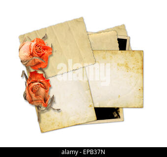 Pile of old photos and letters with bouquet of dried roses on white background isolated Stock Photo