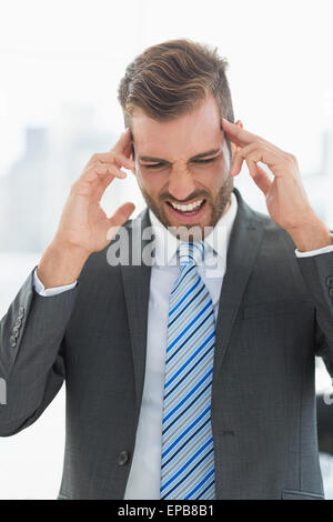 Close-up of a young businessman with headache Stock Photo