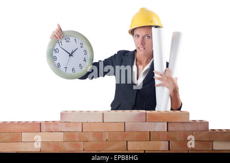 Woman construction worker with clock on white Stock Photo