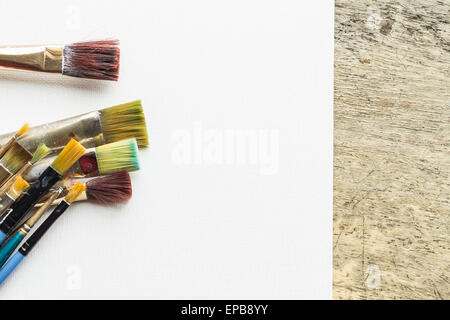 Container kit of assorted and stained old artist paintbrushes Stock Photo