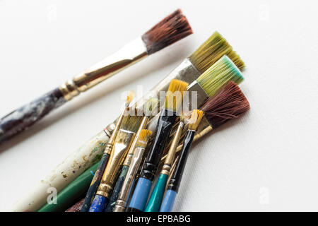 Container kit of assorted and stained old artist paintbrushes Stock Photo