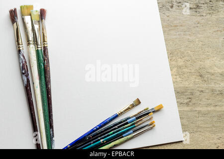Container kit of assorted and stained old artist paintbrushes Stock Photo