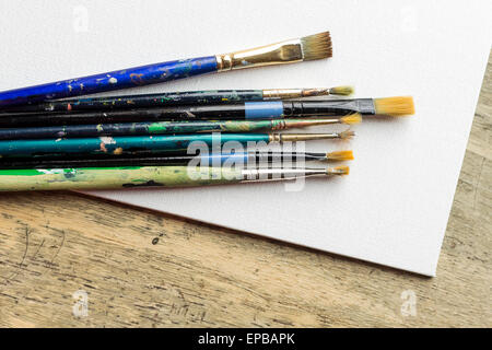 Container kit of assorted and stained old artist paintbrushes Stock Photo