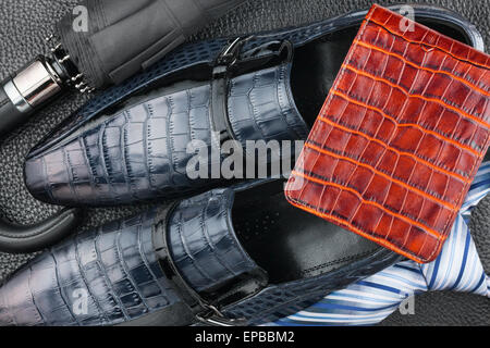 Classic men's shoes, tie, wallet, umbrella on the wooden floor, can be used as background Stock Photo