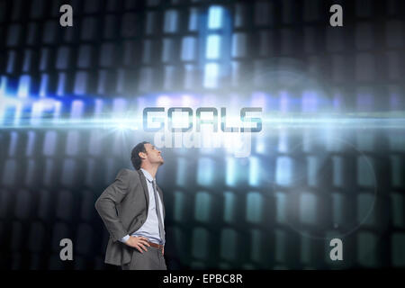 Goals against glowing codes on black background Stock Photo