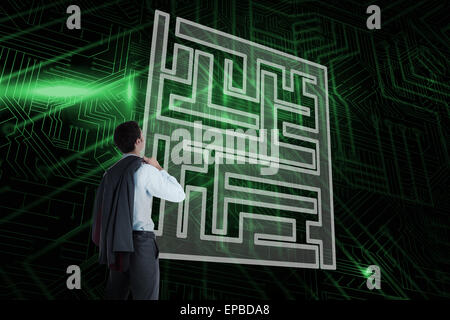 Composite image of maze and businessman looking Stock Photo