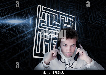 Composite image of maze and businessman tangled in wires Stock Photo