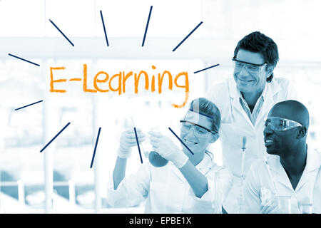 E-learning against scientists working in laboratory Stock Photo