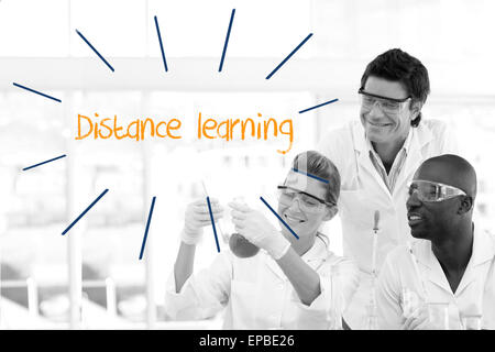 Distance learning against scientists working in laboratory Stock Photo