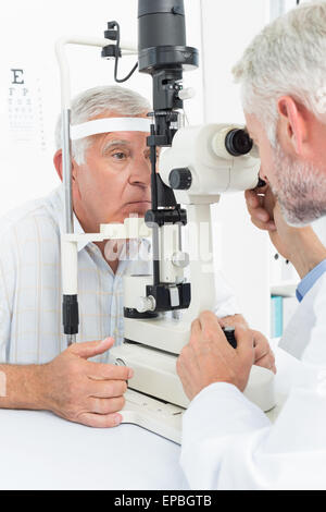 Optometrist doing sight testing for senior patient Stock Photo