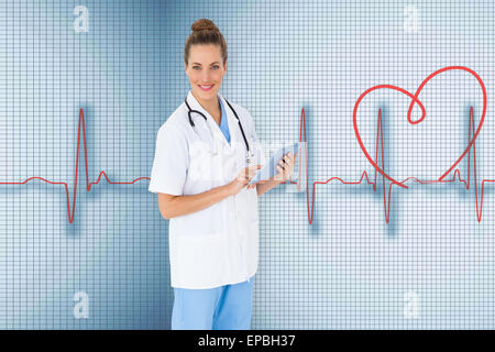 Composite image of pretty nurse using tablet pc Stock Photo