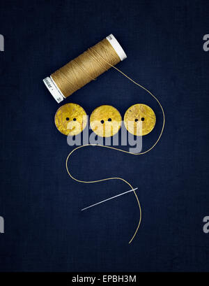 Close up of thread, buttons and needle Stock Photo