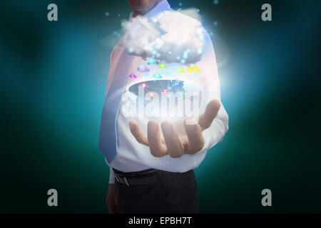 Businessman presenting earth with cloud and app icons Stock Photo