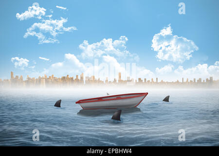 Sharks circling a small boat in the sea Stock Photo