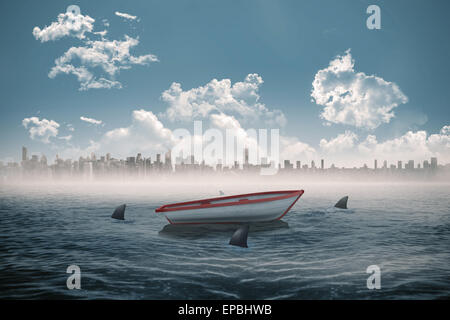 Sharks circling a small boat in the sea Stock Photo